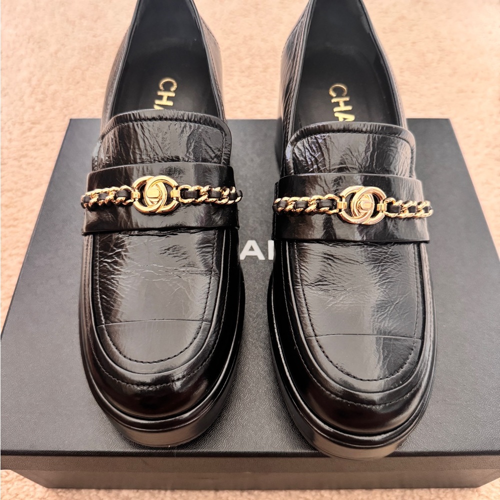CHANEL Glossy Black Loafers with Gold Chain Accent